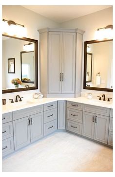 a large bathroom with double sinks and mirrors