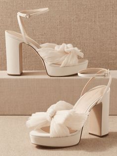 a pair of white high heeled shoes with ruffles on the toes and platform