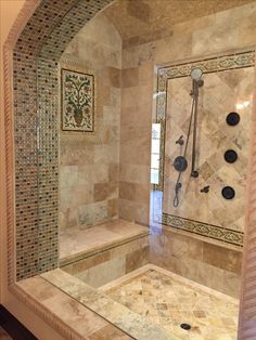 a walk in shower sitting inside of a bathroom next to a tiled wall and floor