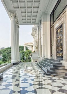 an ornate building with columns and marble flooring