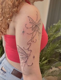 a woman with a butterfly tattoo on her left arm and shoulder is looking at the camera