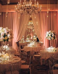 an elegant wedding reception with chandeliers and flowers