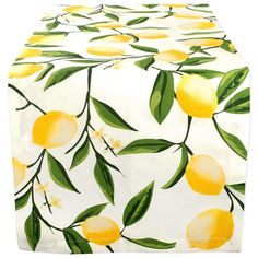 a table cloth with lemons on it and green leaves around the edges is shown