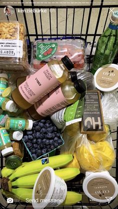 a shopping cart filled with groceries and condiments