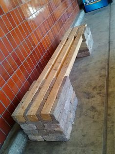 two wooden benches sitting next to each other in front of a red tiled wall and floor