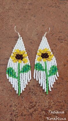 "These handmade unique earrings \"Sunflower\" are made of high-quality Czech beads and strong synthetic thread. I use my author's scheme . They are elegant, fashionable, and highly versatile, suitable for everyday wear. Color: white,yellow,brown,green . Copy without my permission is prohibited For those who want to buy my copyright scheme for these earrings: https://www.etsy.com/uk/listing/1056785837/brick-stitch-pattern-for-seed-bead?ref=shop_home_active_2 100% hand made with love! Measurements Sunflower Beaded Earrings, Chandelier Boho, Native Earrings, Beaded Earrings Native, Earrings Chandelier, Brick Stitch Pattern, Gifts For An Artist, Seed Bead Earrings, White Earrings