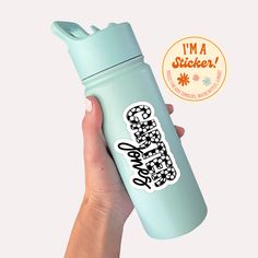 a hand holding a blue water bottle with the words i'm a sticker on it