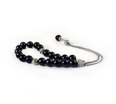 Handcrafted Greek Komboloi - Worry Beads created from silver tone metal chain of 20 black onyx Beads, 2 metal round beads and triangle shape metal Master Bead. A pocket sized set of greek worry beads which can be used for passing time and relaxation. It would also make a beautiful gift. Features: Item Length: 23cm / 9 inches Beads Size: 10mm / 0.40 inches Beads Material: Black onyx beads Metal Materials: Silver tone alloy Here you can browse more items in our shop: https://www.etsy.com/shop/sunn Greek Worry Beads, Chistmas Gift, Worry Beads, Onyx Bead, Beaded Material, Triangle Shape, Necklace Sizes, Metal Beads, Metal Chain