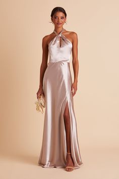 a woman in a long silver dress with high slits and a halter top