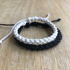 "These lovely bracelets are made with hemp cord. Designed for couples. The smaller bracelet is color white and closes to around 6\"inches. It opens to around 9\" inches. The larger bracelet is color black and closes to around 7\" inches. It opens to around 10\". These bracelets are perfect for couples. Includes Gift Box." Handmade White Braided Bracelets For Everyday, Casual White Braided Bracelets For Everyday, White Friendship Bracelets With Sliding Knot In Waxed Cord, White Friendship Bracelet With Sliding Knot And Waxed Cord, White Braided Bracelets With Adjustable Waxed Cord, White Braided Bracelet With Adjustable Waxed Cord, Casual White Adjustable Braided Bracelets, Casual Adjustable White Braided Bracelet, Adjustable White Waxed Cord Friendship Bracelets