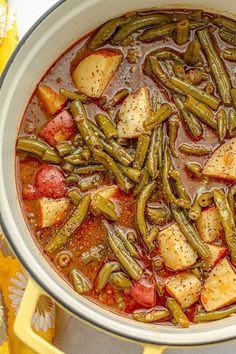 a pot filled with green beans and potatoes