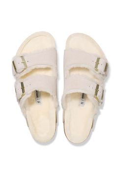 a pair of white slippers with straps