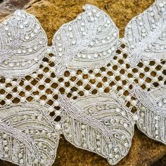 two white lace doilys sitting on top of a rock