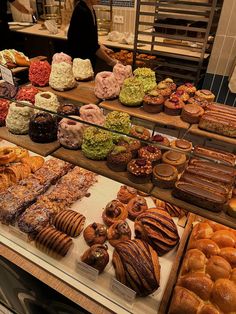 a bakery filled with lots of different types of donuts and pastries on display