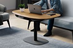 a man sitting at a table using a laptop computer