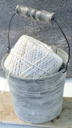 a white ball of yarn sitting in a bucket