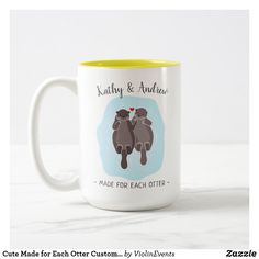 two coffee mugs sitting on top of a table