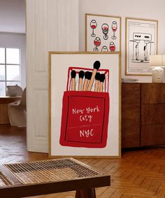 there are many brushes in a red bag on the floor next to pictures and a table