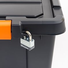 an orange padlock on the side of a black container with a lock attached to it