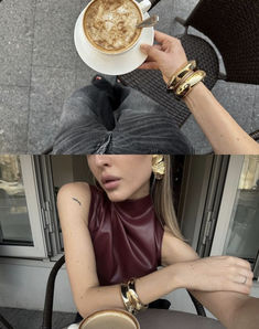 a woman sitting at a table with a cup of coffee in her hand