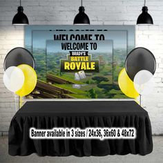 a table topped with balloons next to a sign that says welcome to battle royale on it