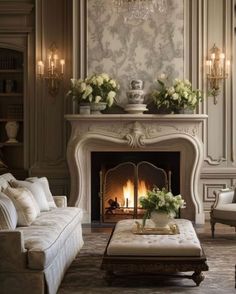 a living room filled with furniture and a fire place in front of a wall mounted fireplace