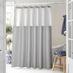 a bathroom with a shower curtain and rug