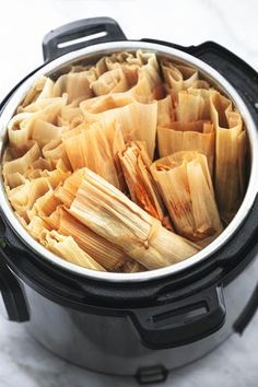 an open crock pot filled with cooked food