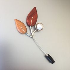 This branch brooch is hand fabricated from sterling silver, Okoume (orange),Padouk (red) woods and fresh water pearl.I t is the natural color of the woods. There is no paint on them. This botanical jewelry will be a great 5th anniversary gift for her or a lovely gift for women for any occasion.    The length of leaves broach is approx.4.1 inches (10.5 cm). - The contemporary shawl clip weighs approx. 0.29 ounce ( 8.2 g) - You'll get the wooden pin in a box ready to give away and also you can add Wooden Gifts For Her, Red Woods, Gifts For My Girlfriend, Botanical Jewelry, 5th Anniversary, Black Accessories, Fresh Water Pearl, Silver Accessories