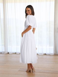 Dare to stand out in this KIMONA SMOCKED MAXI DRESS. The flowy skirt and puff short sleeves create an effortless yet powerful style. Make a bold statement in this summer staple. Size Guide: Model is 5’6” tall, and has a 33.2” bust, 26.4” waist, & 35.2” hips. She is wearing a S / US 4 / AU 8. This dress is true to size. Material: 100% Rayon. Feature: Maxi length. Puff sleeves. V-neckline. Flowy Skirt. Care Instructions: Machine wash / Cold hand wash