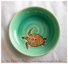 a green bowl with a turtle painted on it