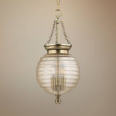 a chandelier hanging from a ceiling with two lights on each side and one light in the middle