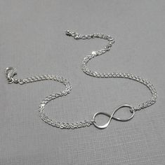 Sterling silver infinity charm on sterling silver bracelet chain Bracelet default length: 6.5 inches with one inch extender.  For other lengths, please select from drop down list. FOR ADD-ON INITIAL CHARMS: https://www.etsy.com/listing/195767821/add-an-initial-charm?ref=shop_home_active_9 MORE INFINITY JEWELRY IN THE STORE: https://www.etsy.com/shop/alexandreasjewels/search?search_query=infinityℴ=date_desc&view_type=gallery&ref=shop_search MULTIPLE QUANTITIES: Please select from drop down list C Bridesmaid Gift Bracelet, Bridesmaid Pearl Bracelet, Swarovski Pearls Bracelet, Silver Infinity Bracelets, Bridesmaid Bracelet Gift, Swarovski Pearl Necklace, Bridesmaid Necklace Gift, Silver Bridesmaid, Infinity Jewelry