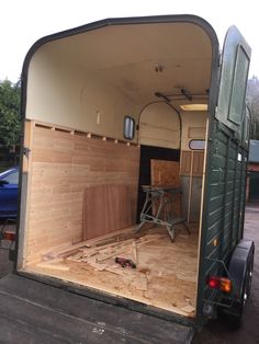 the inside of a horse trailer that is being built with wood and plywood boards