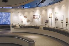 a curved room with several displays on the wall