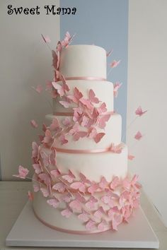 a three tiered cake with pink butterflies on it and the words sweet map?