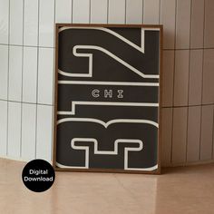 a black and white sign sitting on top of a counter next to a tiled wall