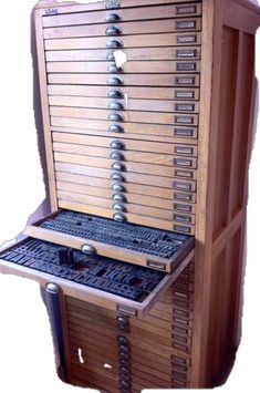 an old fashioned wooden computer with many keys