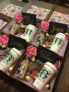 six starbucks coffee cups are in a box with name tags on them, and pink flowers