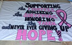 a banner with pink ribbon on it that says support the fighters and advertisers