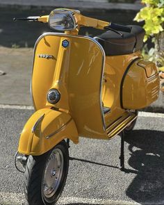 a yellow scooter is parked on the street