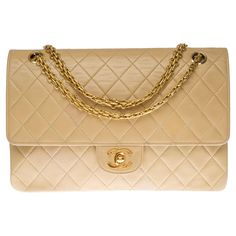 Beautiful Chanel Timeless/Classic handbag with double flap in beige quilted lambskin, gold-plated metal hardware, a Mademoiselle gold-plated metal chain handle allowing a hand or shoulder support A patch pocket on the back of the bag Inner lining in beige leather, a double patch pocket, a lipstick liner Signature: "Chanel Paris®Made in France" Date: Before 1986 and the appearance of the hologram Dimensions: 26 * 18 * 7 cm (10.23 * 7.08 * 2.75 In.) Chain length: 41 cm (16.14 In.) Reference: 12126 Lipstick Liner, Shoulder Support, Flap Shoulder Bag, Classic Handbags, Chanel Paris, Timeless Classic, Metal Chain, Fashion Handbags, Chain Strap