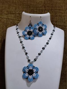 a necklace and earring set made out of beaded beads with flowers on them