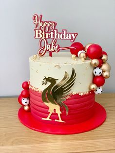 a birthday cake decorated with red and gold decorations