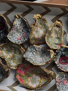 a box filled with lots of different types of decorative dishes on top of a table