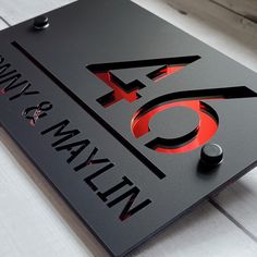 a black and red sign sitting on top of a white floor