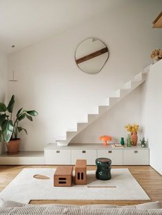 a living room with white walls and wooden floors