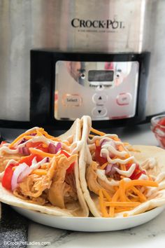 crock pot chicken ranch tacos on a plate in front of an instant pressure cooker