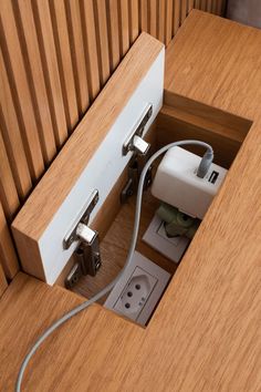 an electrical outlet is plugged into a wooden cabinet