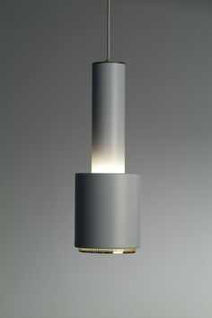 a light that is hanging from a ceiling in a room with grey walls and flooring